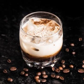 White russian with coffee beans on a table Stock Photos