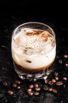 White russian with coffee beans on a table Stock Photos