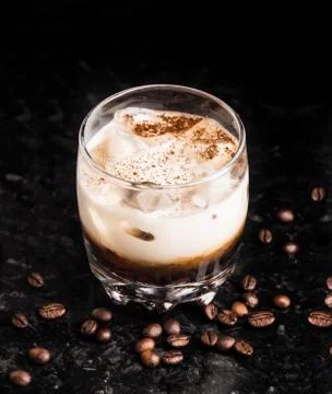 White russian with coffee beans on a table Stock Photos