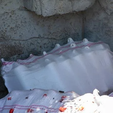 White sacks with red stripes storing construction supplies Stock Photos