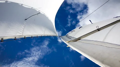 White sail in the wind against a blue sky with clouds in sunny weather Stock Footage