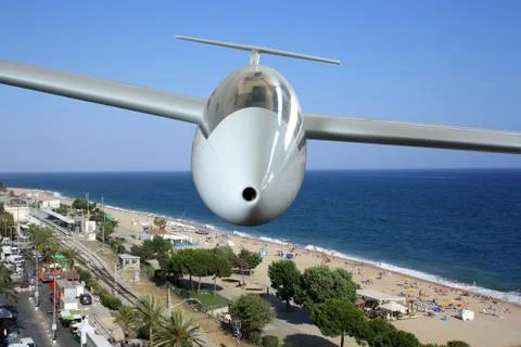 White sailplane flying over sea coast frontal Stock Photos