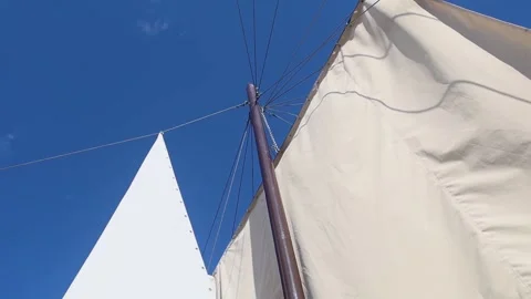 White sails close-up on a background of blue sky with clouds. Yachting and saili Stock Footage 277566760