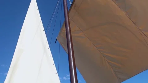 White sails close-up on a background of blue sky with clouds. Yachting and saili Stock Footage 277566768