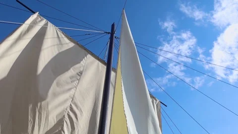 White sails close-up on a background of blue sky with clouds. Yachting and saili Stock Footage 277566775