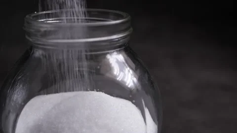 White salt falling into a bottle Stock Footage 160560887