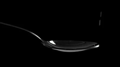 White salt falling down into a spoon, slow motion Stock-Footage 83035411