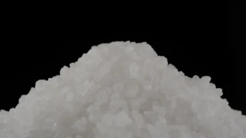 White salt isolated on black background Stock Footage 219627651