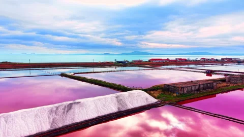 White salt mound in front of pink water and sea Stock Footage 330486737