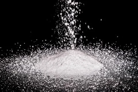 White salt pours onto the table. Table salt Stock Photos