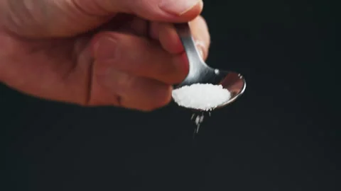 White salt on spoon close-up macro. Spice for food. Sea salt for bath. Man hand Stock Footage 260760274