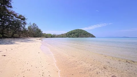 White sand beach and clear turquoise water on a tropical island with jungle Stock Footage 330934008