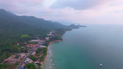 White Sand Beach glows at sunset with tourists along the water,Koh Chang Stock Footage 310264661