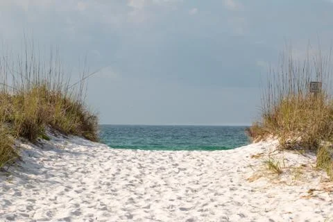 White sand beach path thru the dunes to the shore. Stock Photos