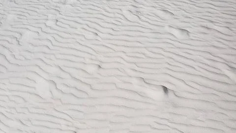 White sand dune texture. Abstract natural background. Close up. Stock Photos