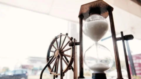 White sand flows through an hourglass Stock Footage 276823618