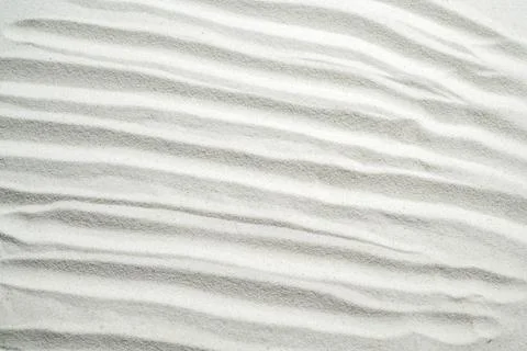 White sand texture with elegant ripple patterns, perfect for zen, relaxatio.. Stock Photos