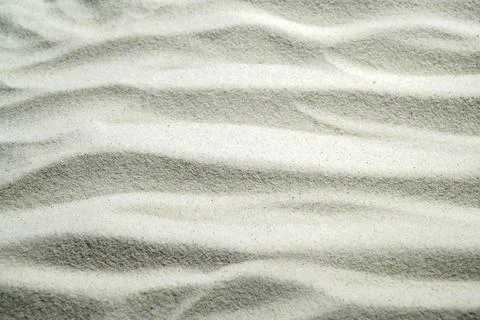 White sand texture with elegant ripple patterns, perfect for zen, relaxatio.. Stock Photos