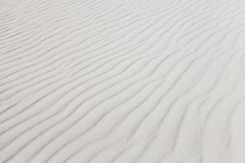White sand with wave pattern. Background photo texture Stock Photos