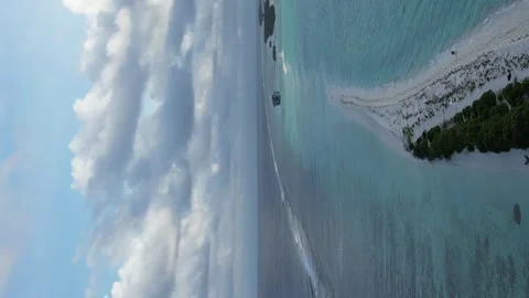 White sandbank of Long Beach on Dhigurah Island, Maldives. Vertical Aerial 動画素材 242500829