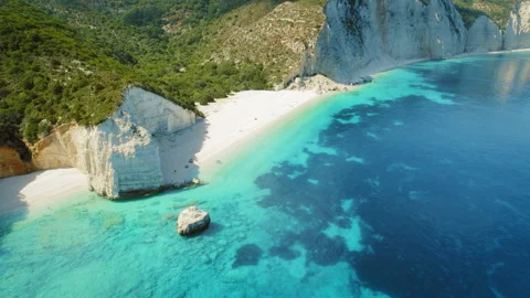 White sandy beach and turquoise waters surrounded by cliffs in Kefalonia Greece Stock Footage 341297091