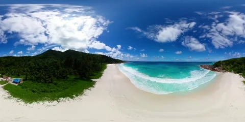 White sandy beach with lush green backdrop. La Digue, Seychelles. Stock Footage 308147545