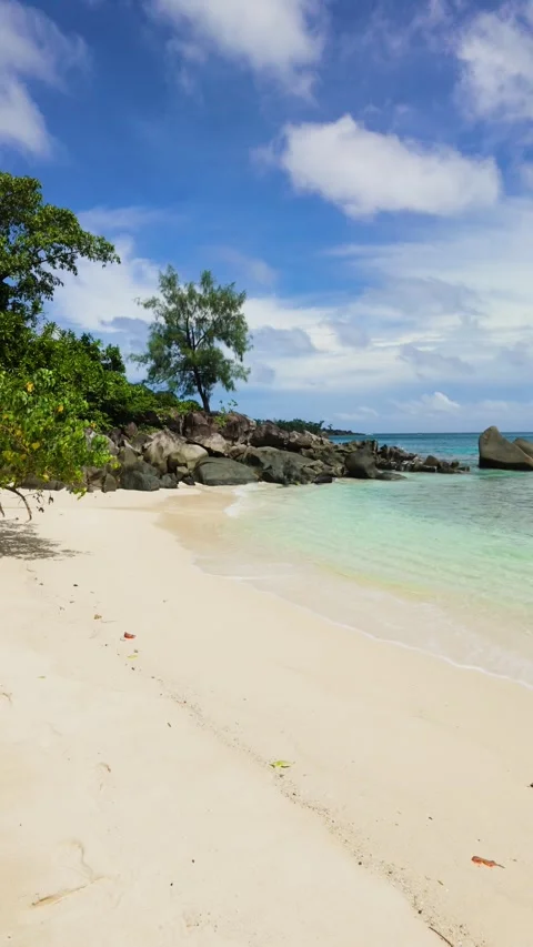White sandy beach with turquoise water and rocks. Seychelles, Mahe. Stock Footage 301941158