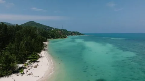 White sandy beach with turquoise waters and forested hills. Ko Pha Ngan Stock Footage 342642635