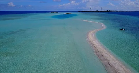 White sandy path snakes through the turquoise lagoon and disappears into Stock Footage 119195596