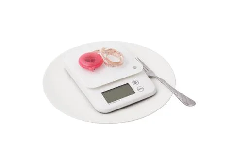 White scales and tapeline on a plate Stock Photos
