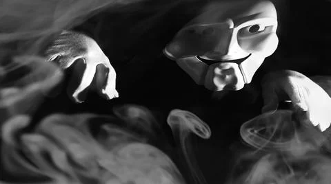White scary mask on a black background with whites hand. Foto stock