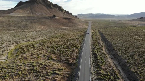 White School Bus Driving Through the Desert - Aerial Drone Stock Footage 198458826