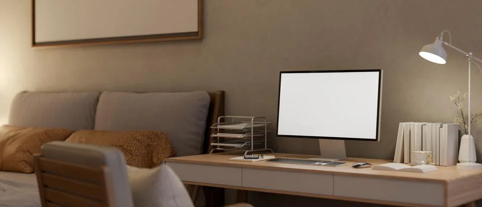 White screen computer with books and lamp aside on wooden table and armchai.. 스톡 일러스트
