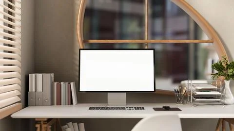 White screen computer with books and folders on wooden table under window i.. Stock Illustration