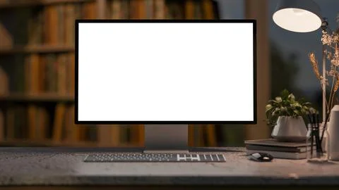 White screen computer with books and desk lamp on stone counter table and b.. Stock Illustration