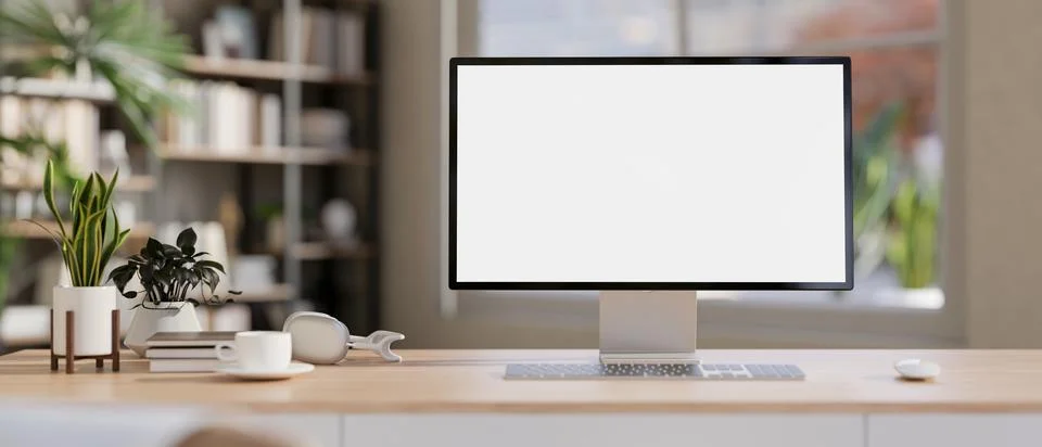 White screen computer with coffee cup aside books and potted plants on wood.. Stock Illustration