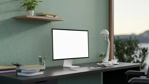 White screen computer with lamp and books on black table in a green wall ro.. イラスト素材