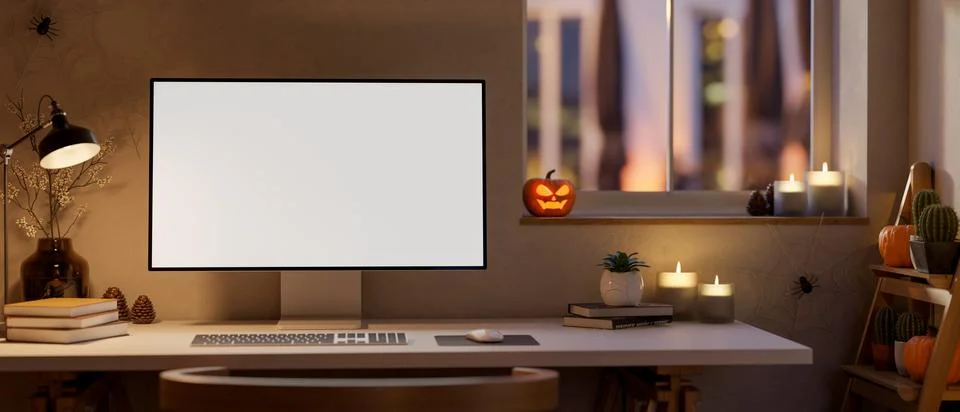 White screen computer on table with halloween pumpkin lanterns and candles .. Stock Illustration