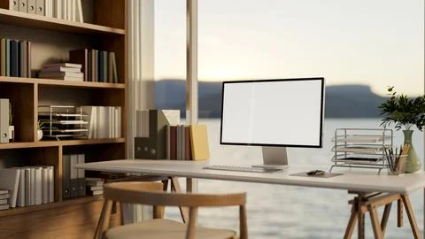 White screen computer on wooden table and chair aside bookshelf in glass wa.. イラスト素材
