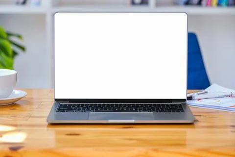 A white screen computer on a wooden table can carry text messages or images on a Stock Photos