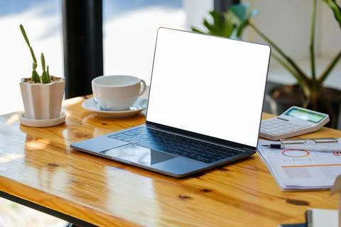 A white screen computer on a wooden table can carry text messages or images on a Stock Photos
