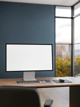 White screen computer on wooden table with a leather chair in dark blue off.. Stock Photos