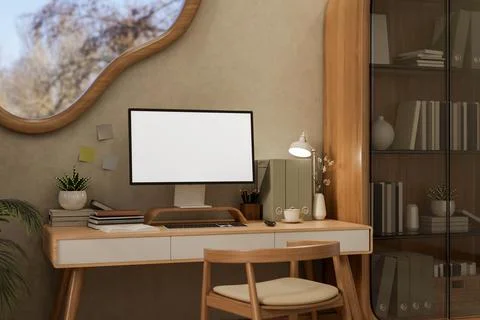White screen computer on wooden table and chair under an odd shape window i.. Stock Photos