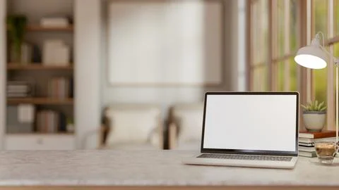White screen laptop and coffee under lamp on marble table aside window in a.. Stock Illustration