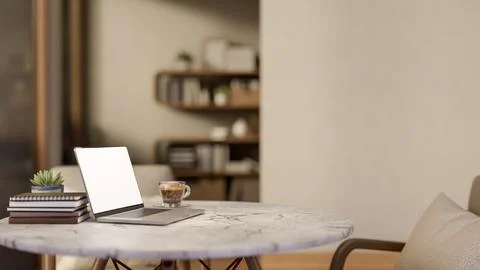 White screen laptop and coffee cup aside book on round marble table and woo.. 스톡 일러스트