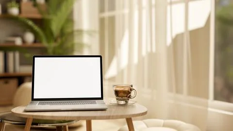 White screen laptop and coffee cup on wooden table at living room floor and.. Stock Illustration