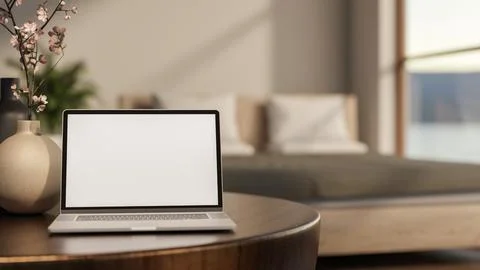 White screen laptop and flower vase on round wooden table with sunlight thr.. Stock Illustration