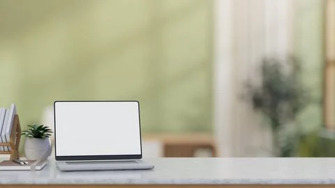 White screen laptop beside bookrack and potted plant on marble countertop t.. Stock Illustration