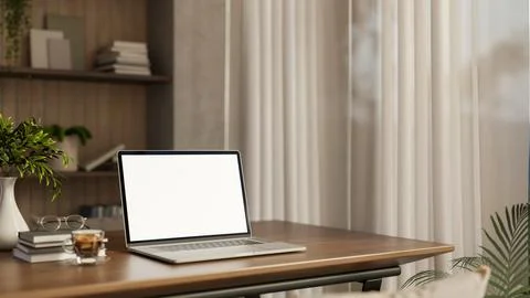 White screen laptop with coffee and book on wooden table aside curtain cove.. 스톡 일러스트
