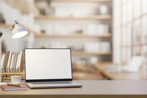 White screen laptop with coffee and book under lamp light on wooden table c.. Stock Illustration
